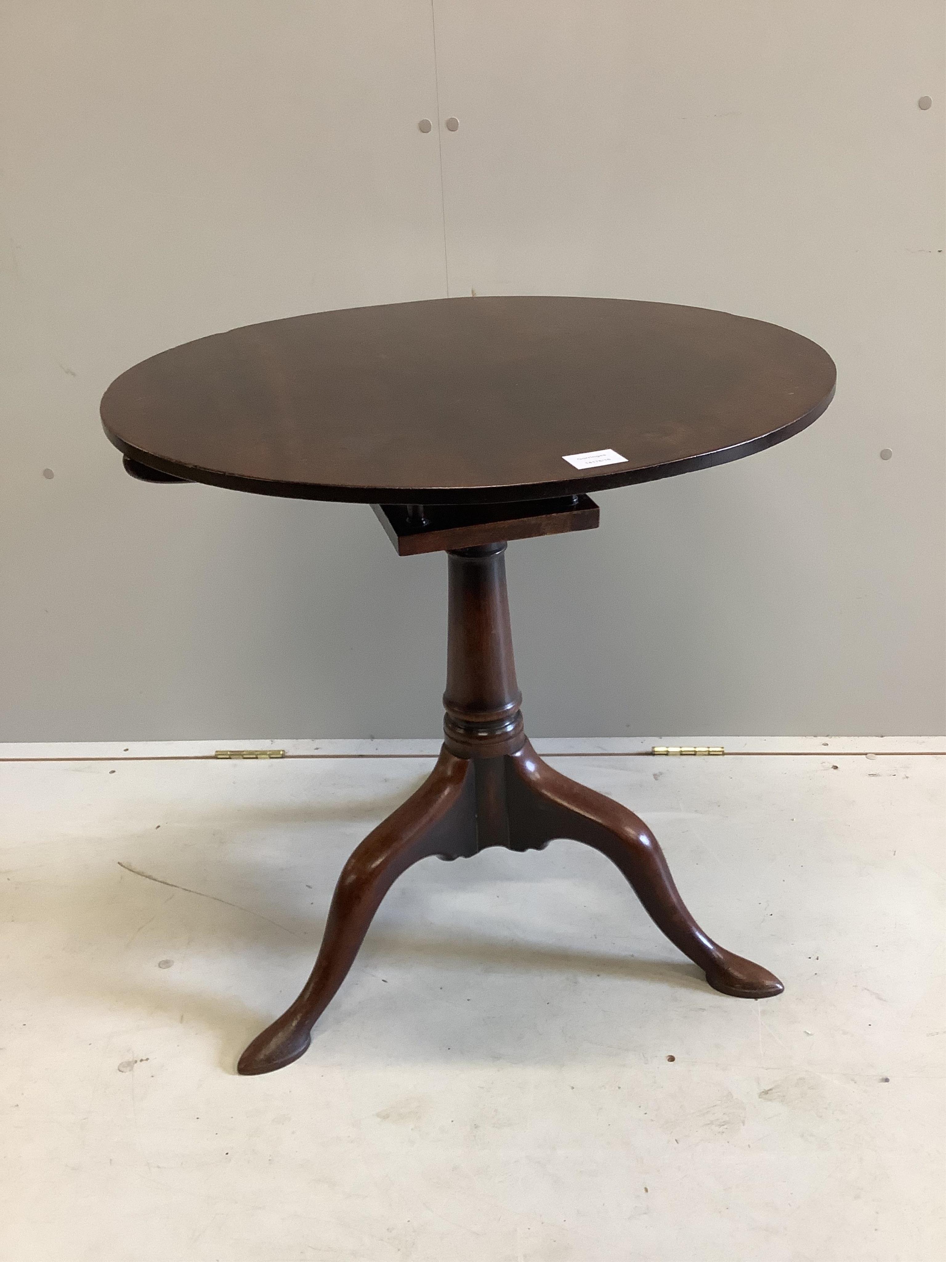 A George III circular mahogany tilt top bird cage tripod tea table, diameter 69cm, height 69cm. Condition - fair